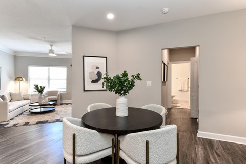 a living room and dining room with a table and chairs